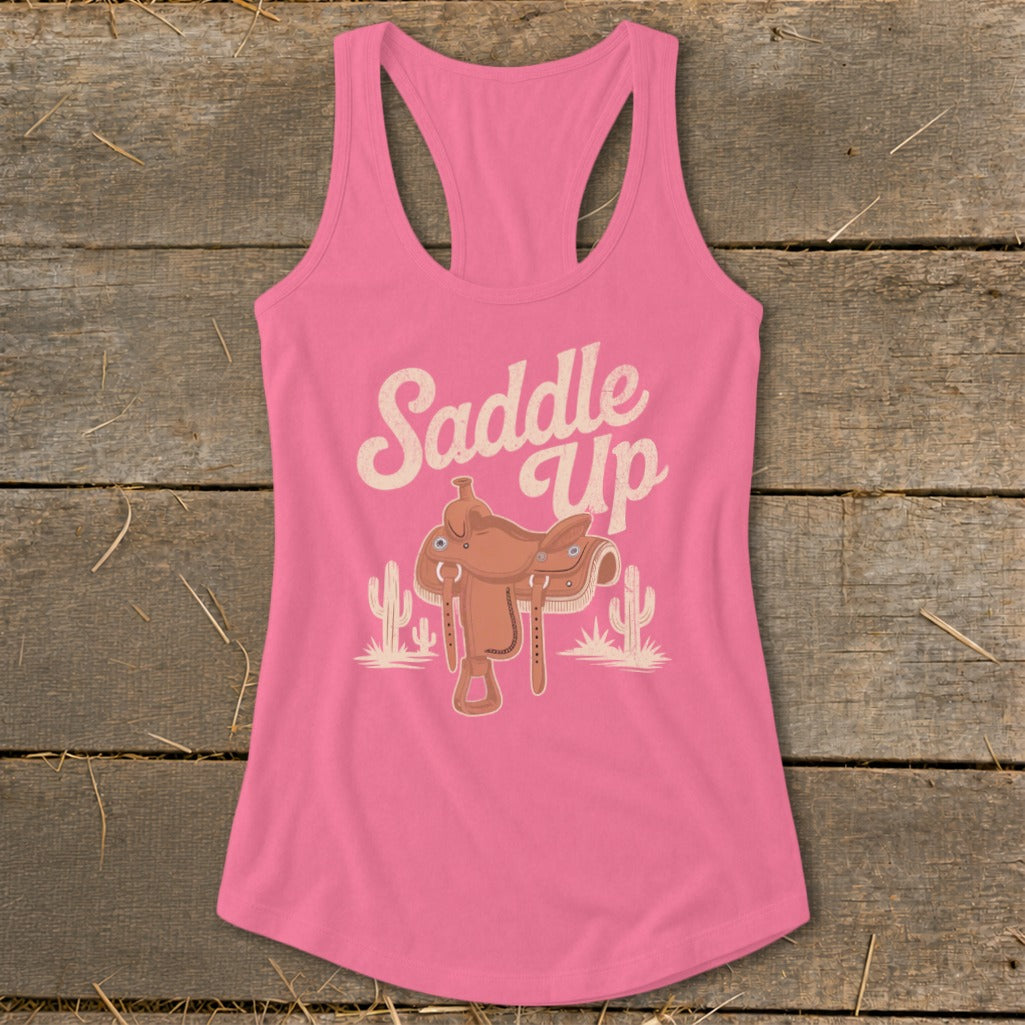 Pink tank top with "Saddle Up" text and a cowboy saddle illustration.