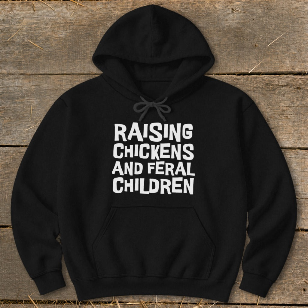 Black hoodie with white text: Raising Chickens and Feral Children.