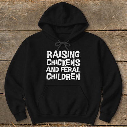 Black hoodie with white text: Raising Chickens and Feral Children.