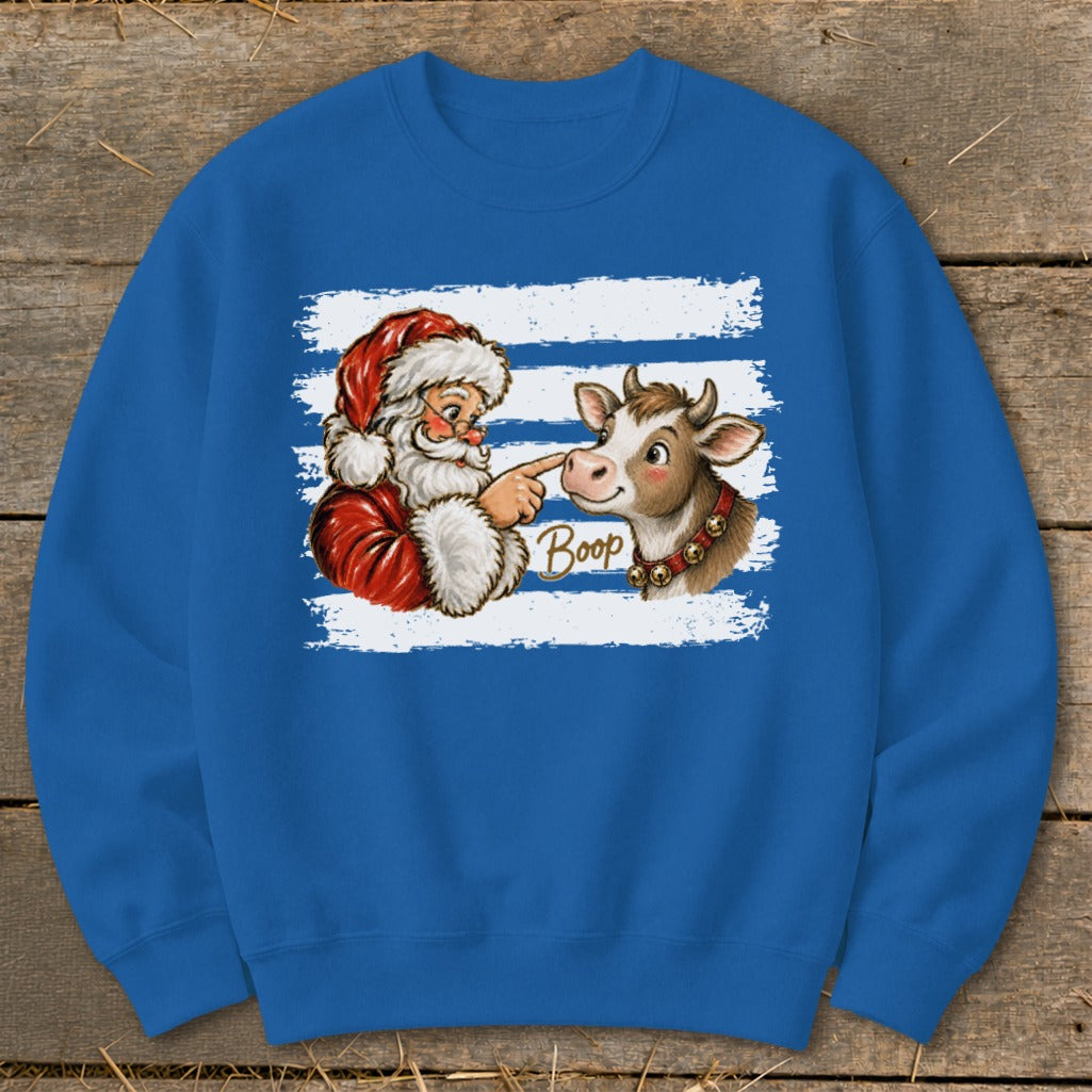 Santa booping a cow's nose with "Boop" text on blue sweatshirt.