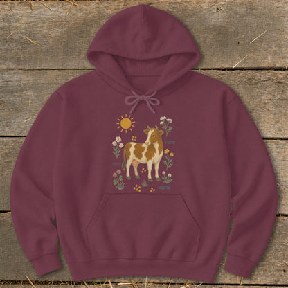 Maroon hoodie with a cow and floral illustration on the front.