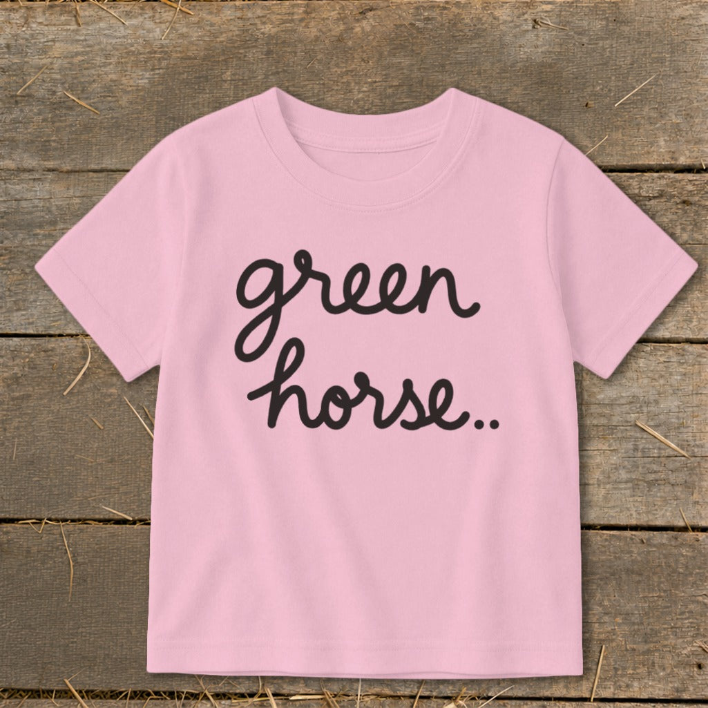 Pink t-shirt with "green horse.." text in black cursive font