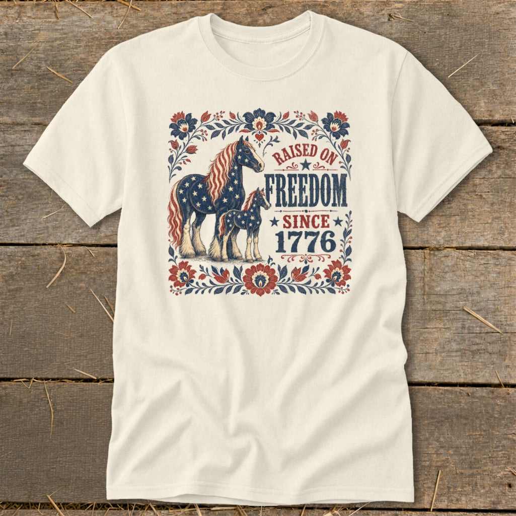 T-shirt with patriotic horses and "Raised on Freedom Since 1776" text.