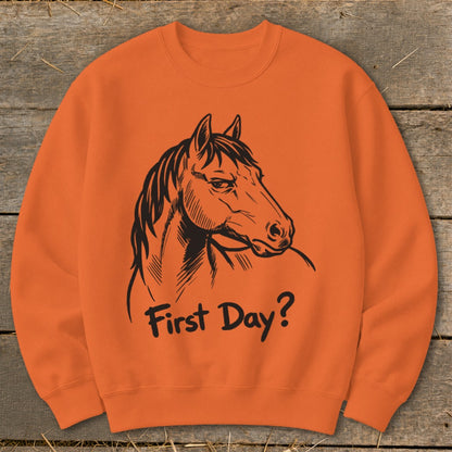 Orange sweatshirt with black horse illustration and "First Day?" text.