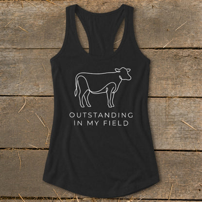 Black tank top with white line art cow and text "OUTSTANDING IN MY FIELD."