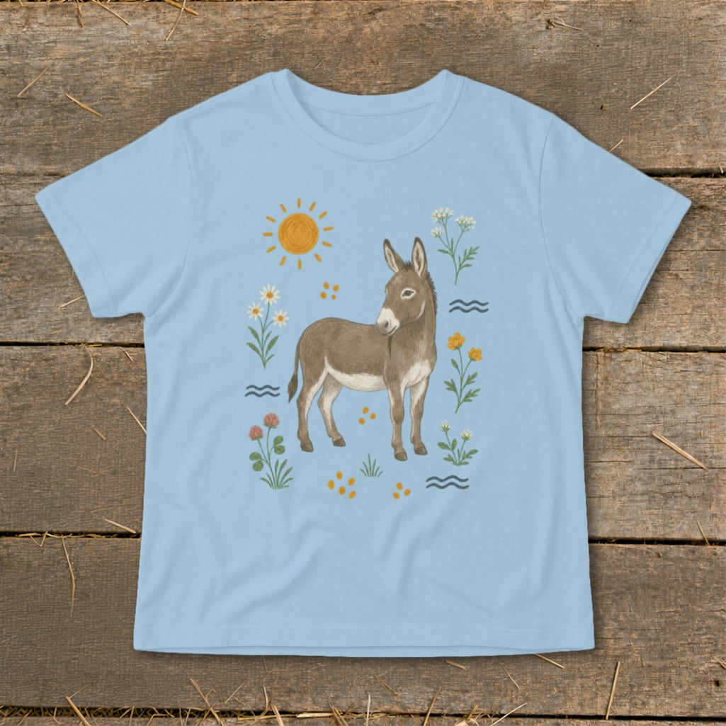 Light blue t-shirt with a drawing of a donkey surrounded by flowers and a sun.