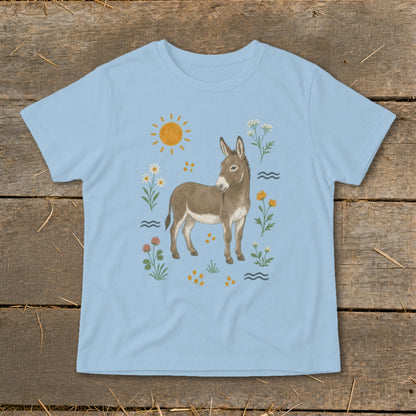 Light blue t-shirt with a drawing of a donkey surrounded by flowers and a sun.