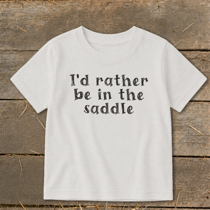 White t-shirt with black text reading "I'd rather be in the saddle".