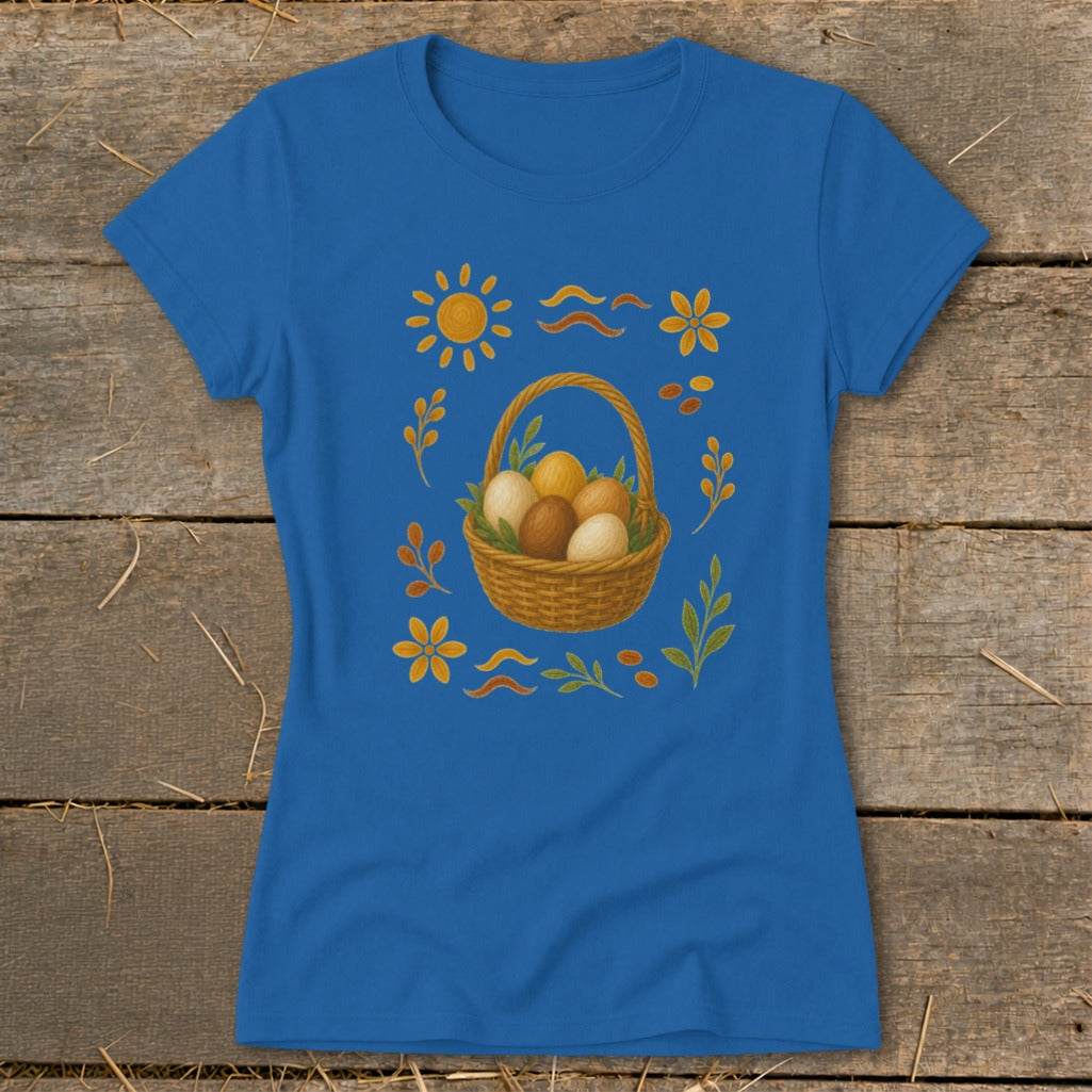 Blue t-shirt with an Easter basket of eggs surrounded by sun, flowers, and leaves.