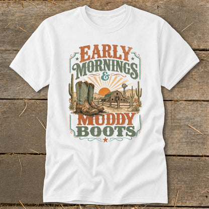 White t-shirt with "Early Mornings & Muddy Boots" graphic featuring cowboy boots, barn, and cactus.