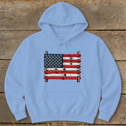 Light blue hooded sweatshirt featuring a graphic of the American flag made of painted wooden planks with horseshoes.