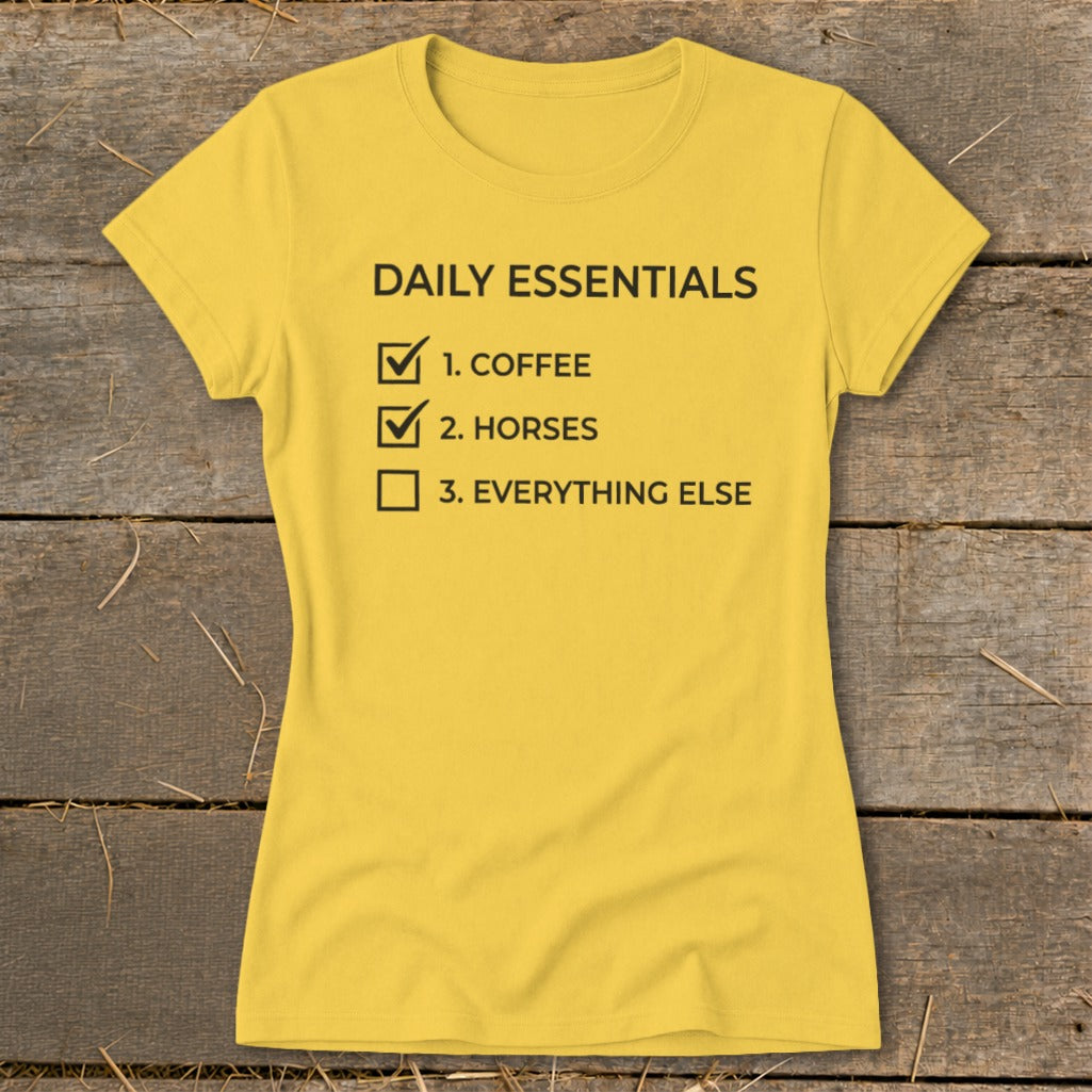 Yellow t-shirt with black text: "Daily Essentials, 1. Coffee, 2. Horses, 3. Everything Else".