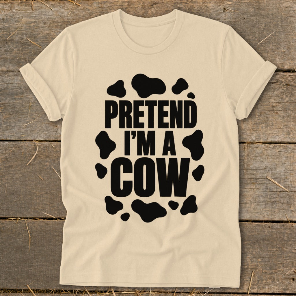 Light cream t-shirt with black "PRETEND I'M A COW" text and cow spots.