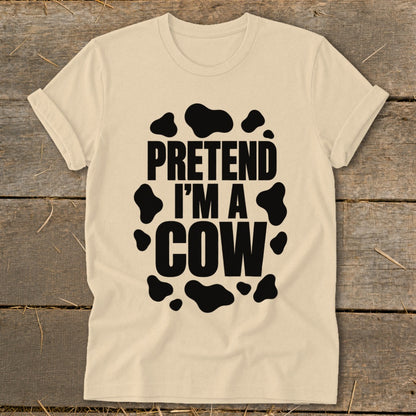 Light cream t-shirt with black "PRETEND I'M A COW" text and cow spots.