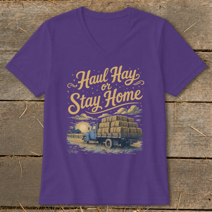 Purple v-neck t-shirt with "Haul Hay or Stay Home" text and hay truck illustration.