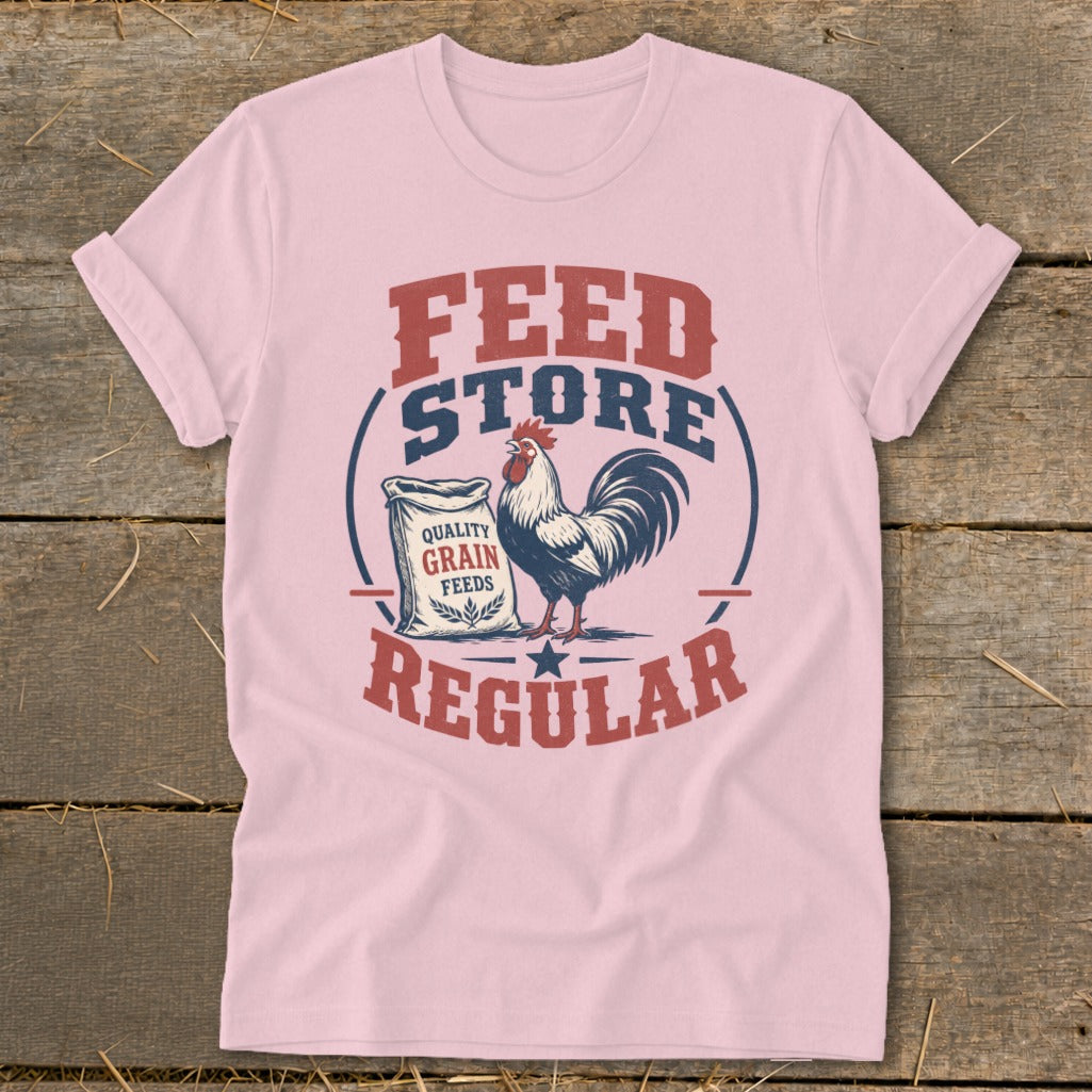 Pink t-shirt with a graphic of a rooster, feed bag, and text "FEED STORE REGULAR".