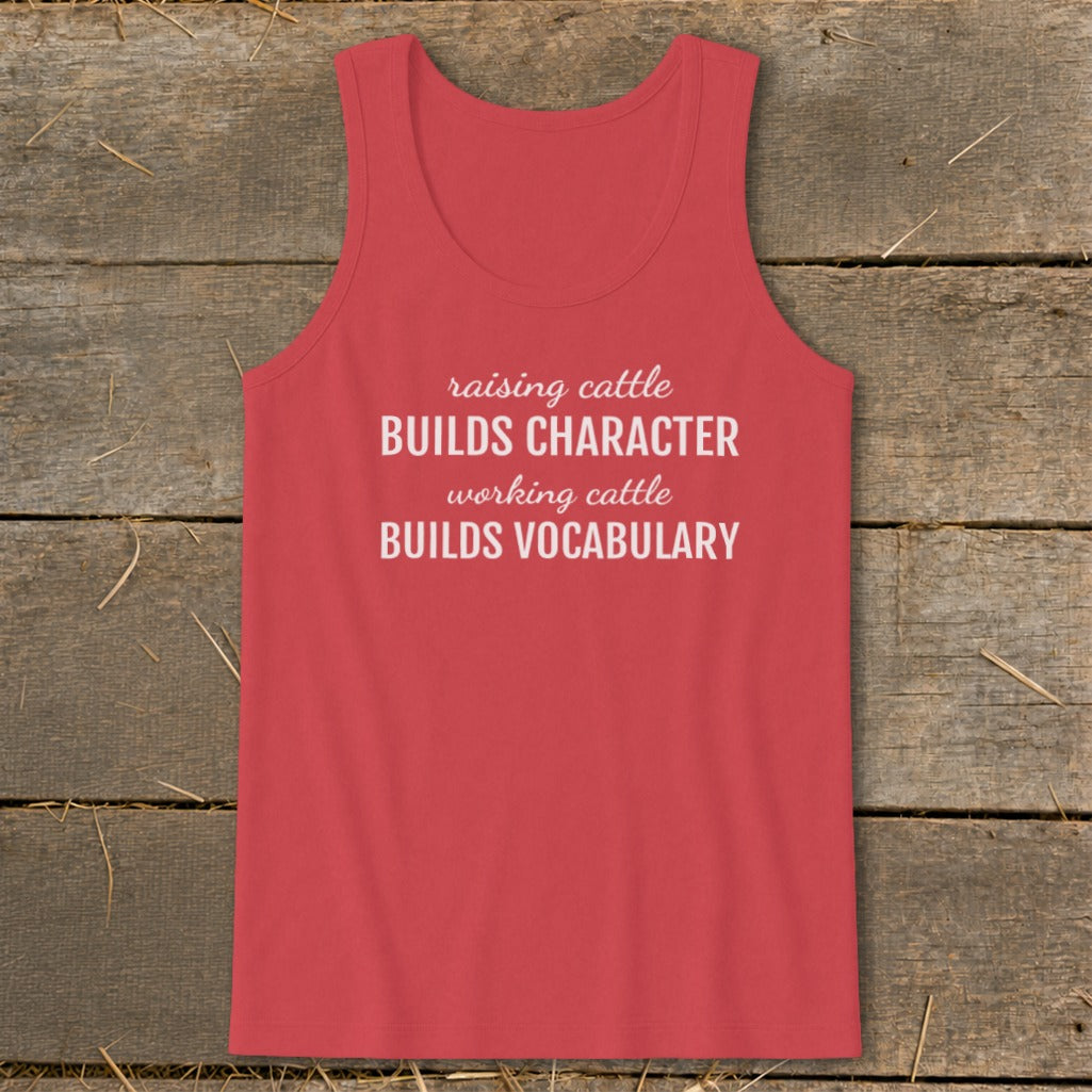 Coral tank top with white text: "raising cattle BUILDS CHARACTER, working cattle BUILDS VOCABULARY."