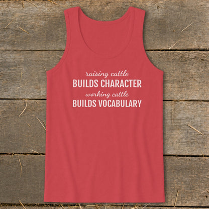 Coral tank top with white text: "raising cattle BUILDS CHARACTER, working cattle BUILDS VOCABULARY."