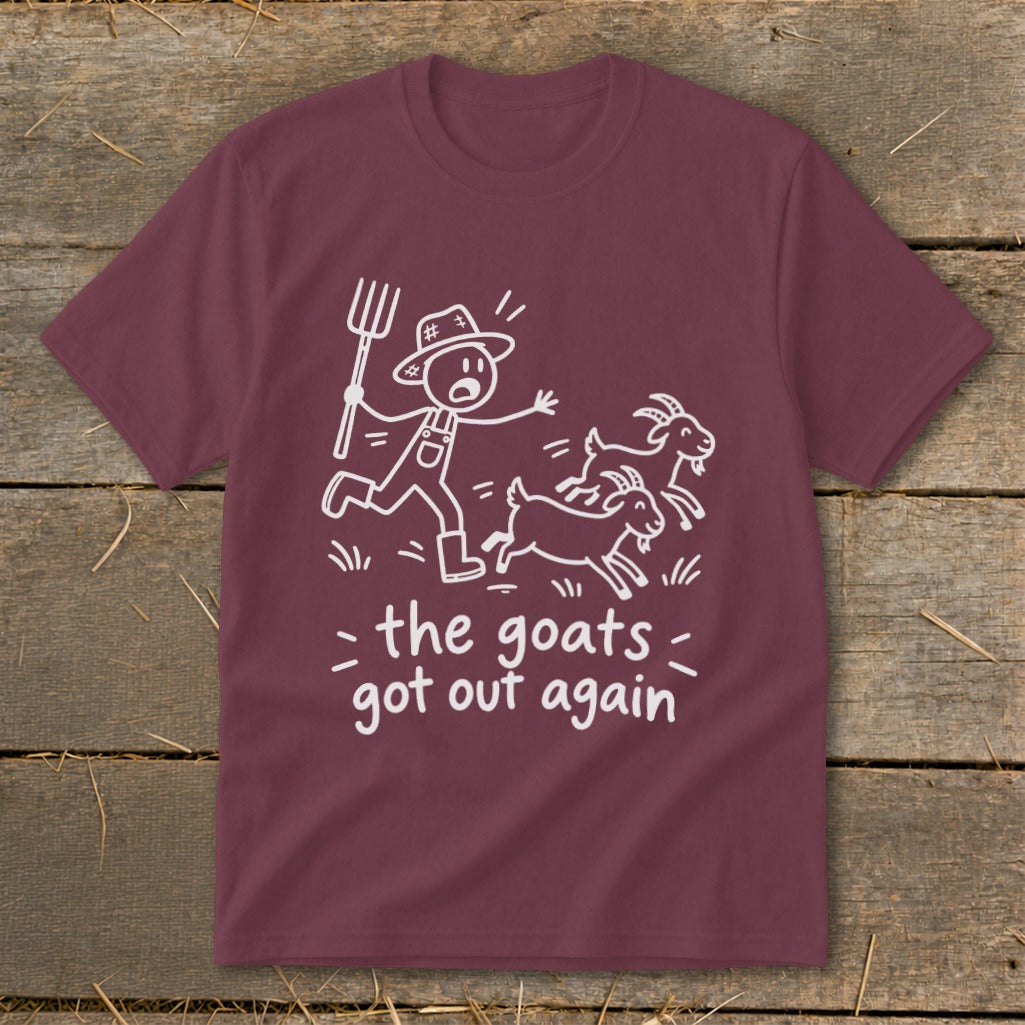 Maroon t-shirt with white line drawing of farmer chasing goats, text "the goats got out again".