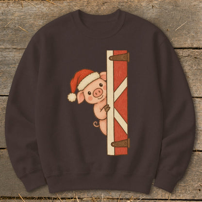 Cartoon pig wearing a Santa hat peeking from behind a red barn door.