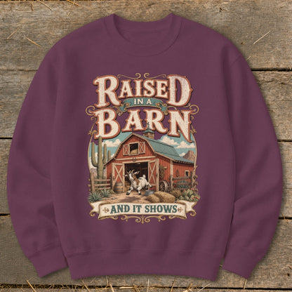 Sweatshirt with "Raised in a Barn and It Shows" text and a goat by a barn.
