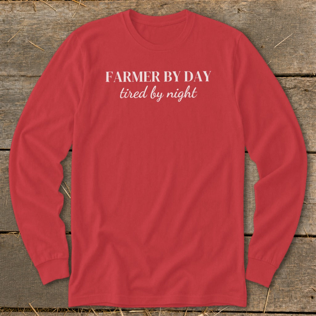 Red long-sleeve shirt with white text "FARMER BY DAY tired by night".