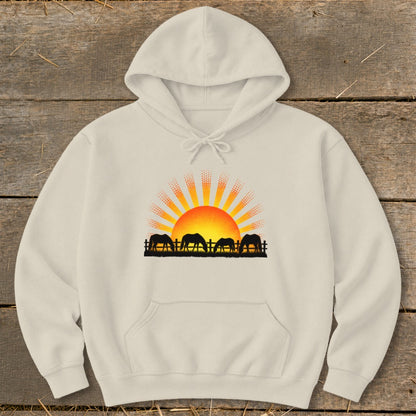 Cream hoodie with a graphic of horses at sunrise behind a fence.