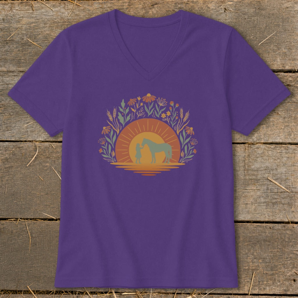 Purple t-shirt with a graphic of a girl and horse at sunset, surrounded by flowers.