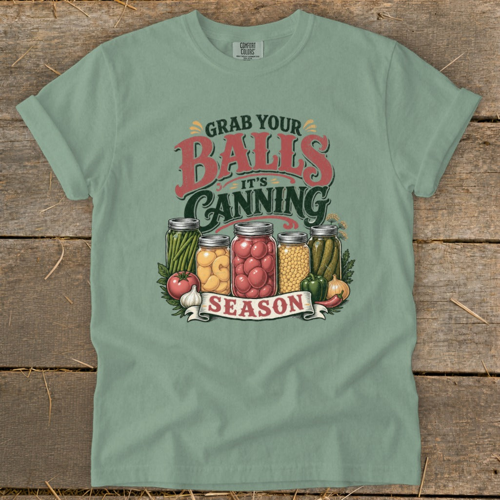 Green t-shirt with "Grab Your Balls It's Canning Season" and jarred vegetables graphic.