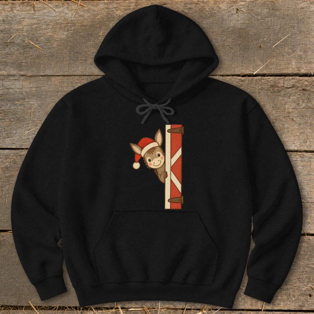 Black hoodie with a cartoon donkey wearing a Santa hat peeking from behind a gate.