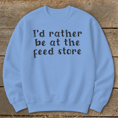 Light blue sweatshirt with black text that reads "I'd rather be at the feed store".