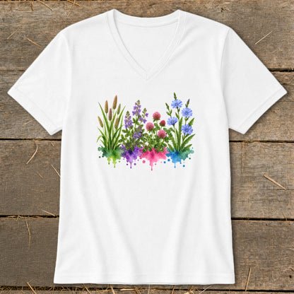A white V-neck t-shirt featuring a colorful watercolor graphic of wildflowers over matching paint splatters.