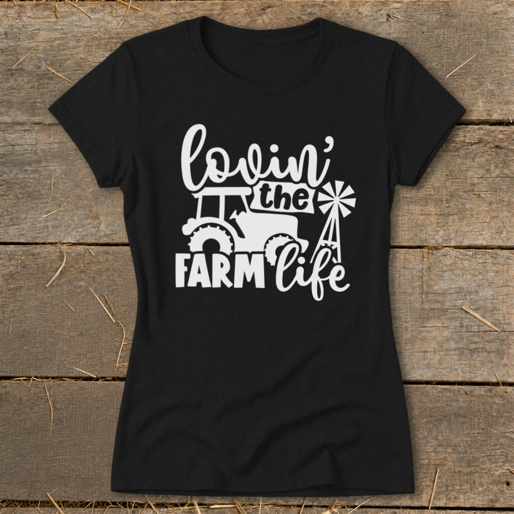 Black t-shirt with white graphic of tractor, windmill, and text "lovin' the FARM life".