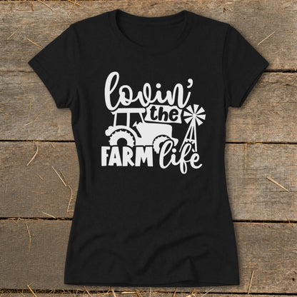 Black t-shirt with white graphic of tractor, windmill, and text "lovin' the FARM life".