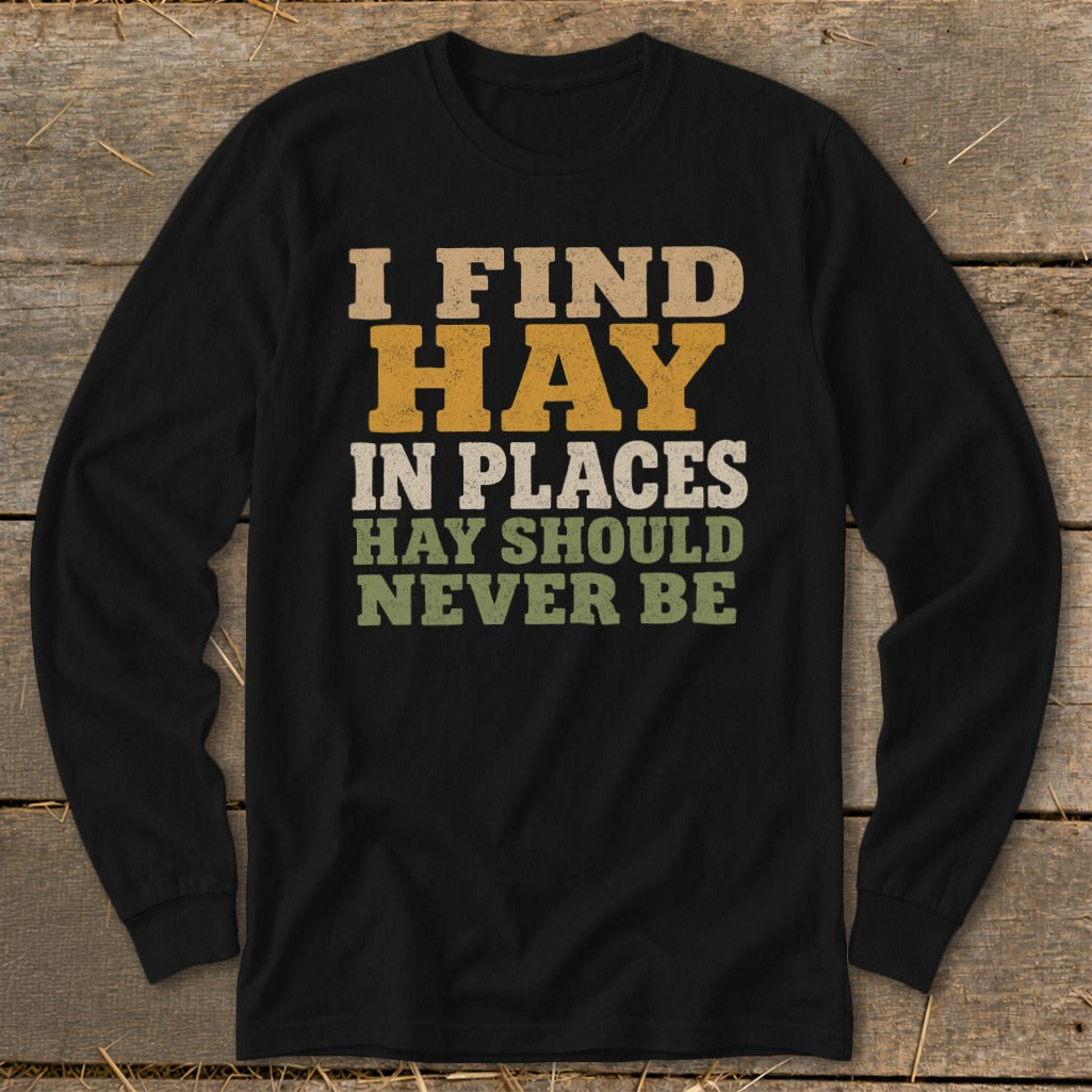 Black long-sleeve shirt with text "I FIND HAY IN PLACES HAY SHOULD NEVER BE".