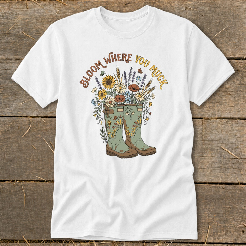 White t-shirt with floral design in boots and text "Bloom Where You Muck."