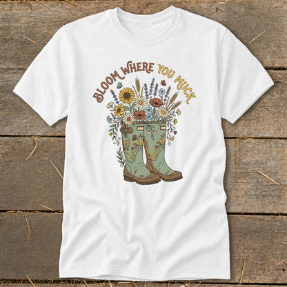White t-shirt with floral design in boots and text "Bloom Where You Muck."