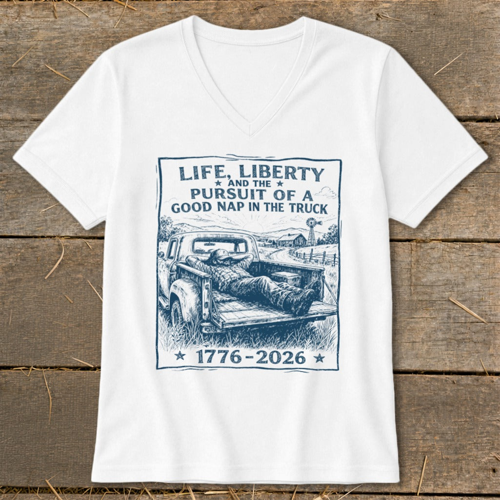 White t-shirt with graphic: man naps in truck bed, text "Life, Liberty, Pursuit of a Good Nap".