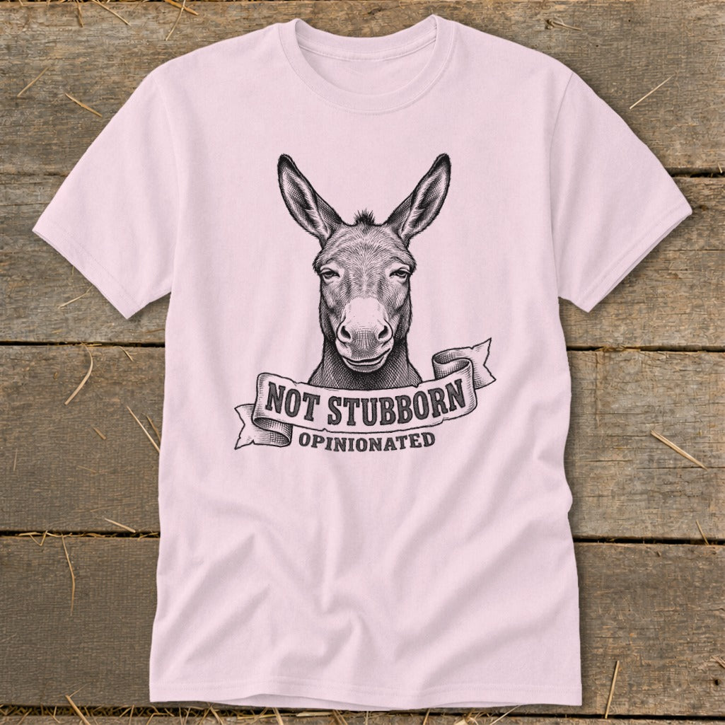Pink t-shirt with drawing of a donkey and text "NOT STUBBORN OPINIONATED".