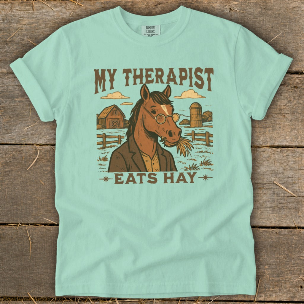 Horse wearing glasses and a jacket, eating hay with text "MY THERAPIST EATS HAY".