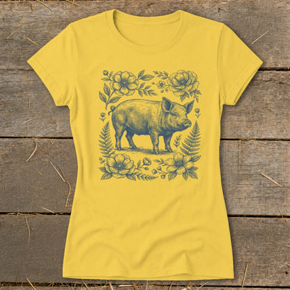 Yellow t-shirt with a navy blue drawing of a pig among flowers and ferns.