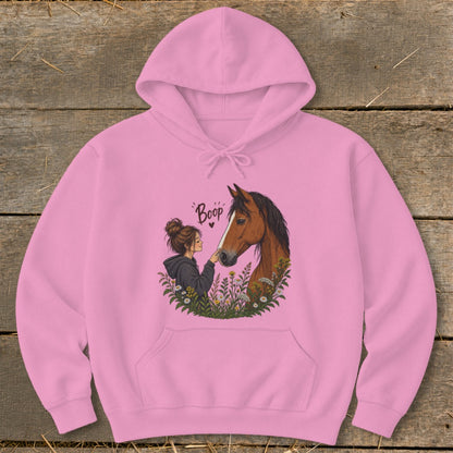 Pink hoodie with artwork of a girl and horse with the word "Boop".