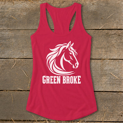 A red women's racerback tank top featuring a white horse head illustration and the text GREEN BROKE, laid flat on a rustic wooden surface.
