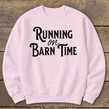 Pink sweatshirt with black text reading "Running on Barn Time".