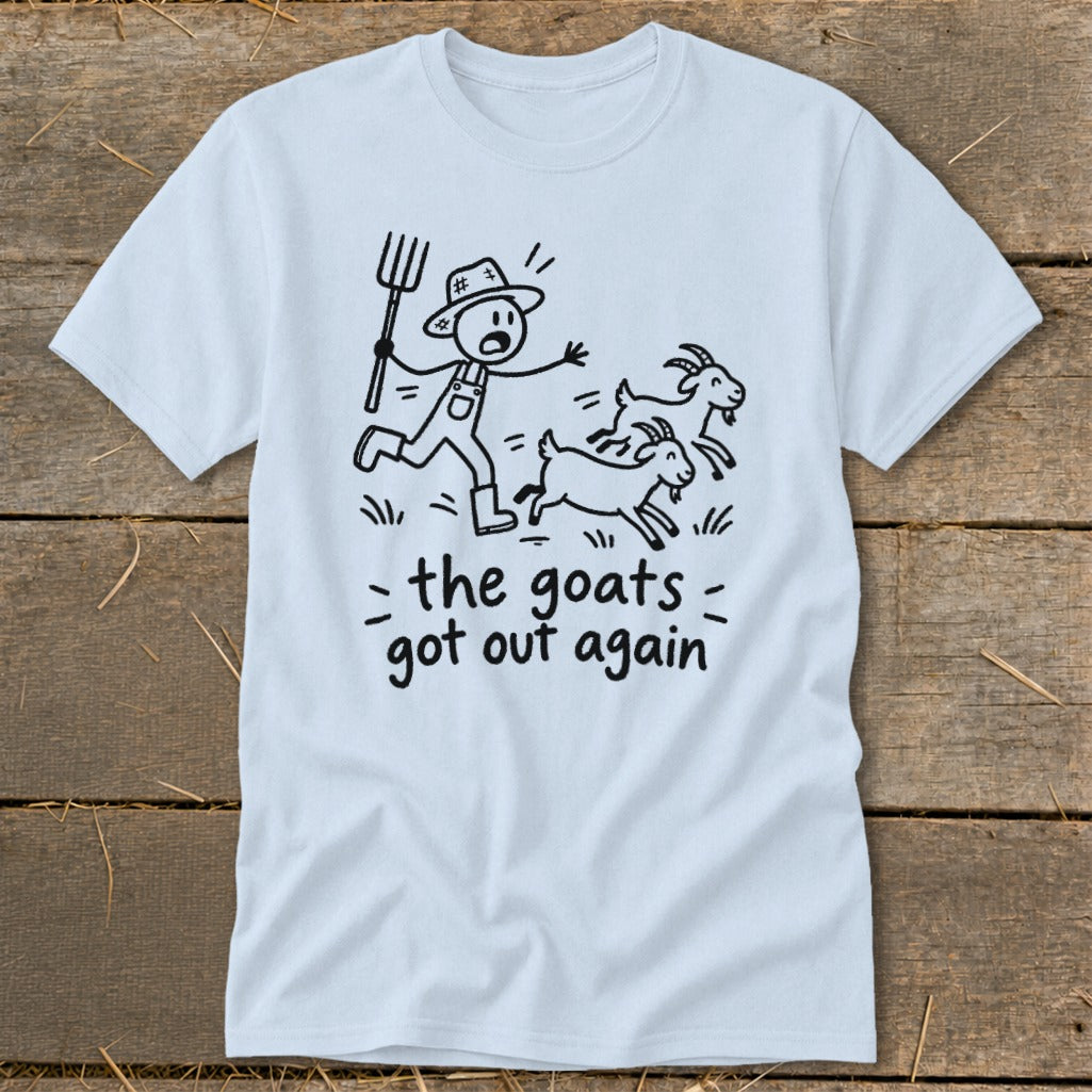 Light blue t-shirt with a stick figure farmer chasing three goats. Text says "the goats got out again".