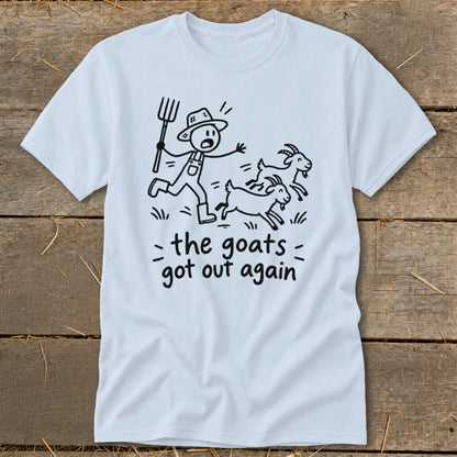 Light blue t-shirt with a stick figure farmer chasing three goats. Text says "the goats got out again".