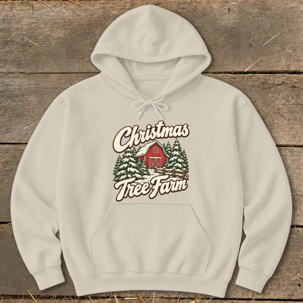 Beige hoodie with "Christmas Tree Farm" graphic featuring a red barn and snow-covered trees.