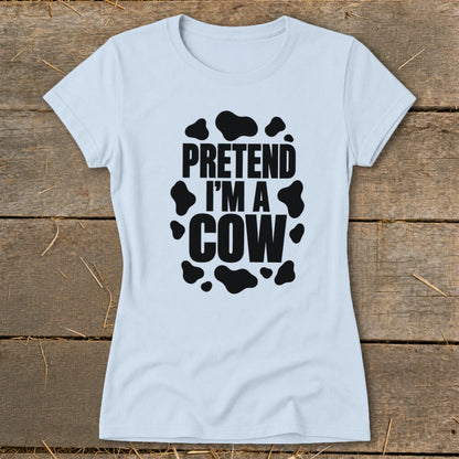 Light blue t-shirt with black text "PRETEND I'M A COW" and cow spots.
