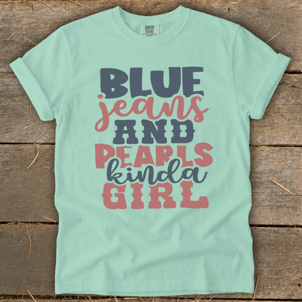 Teal t-shirt with "BLUE jeans AND PEARLS kinda GIRL" text in pink and gray.