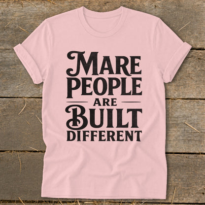 Pink t-shirt with black text "Mare People Are Built Different".
